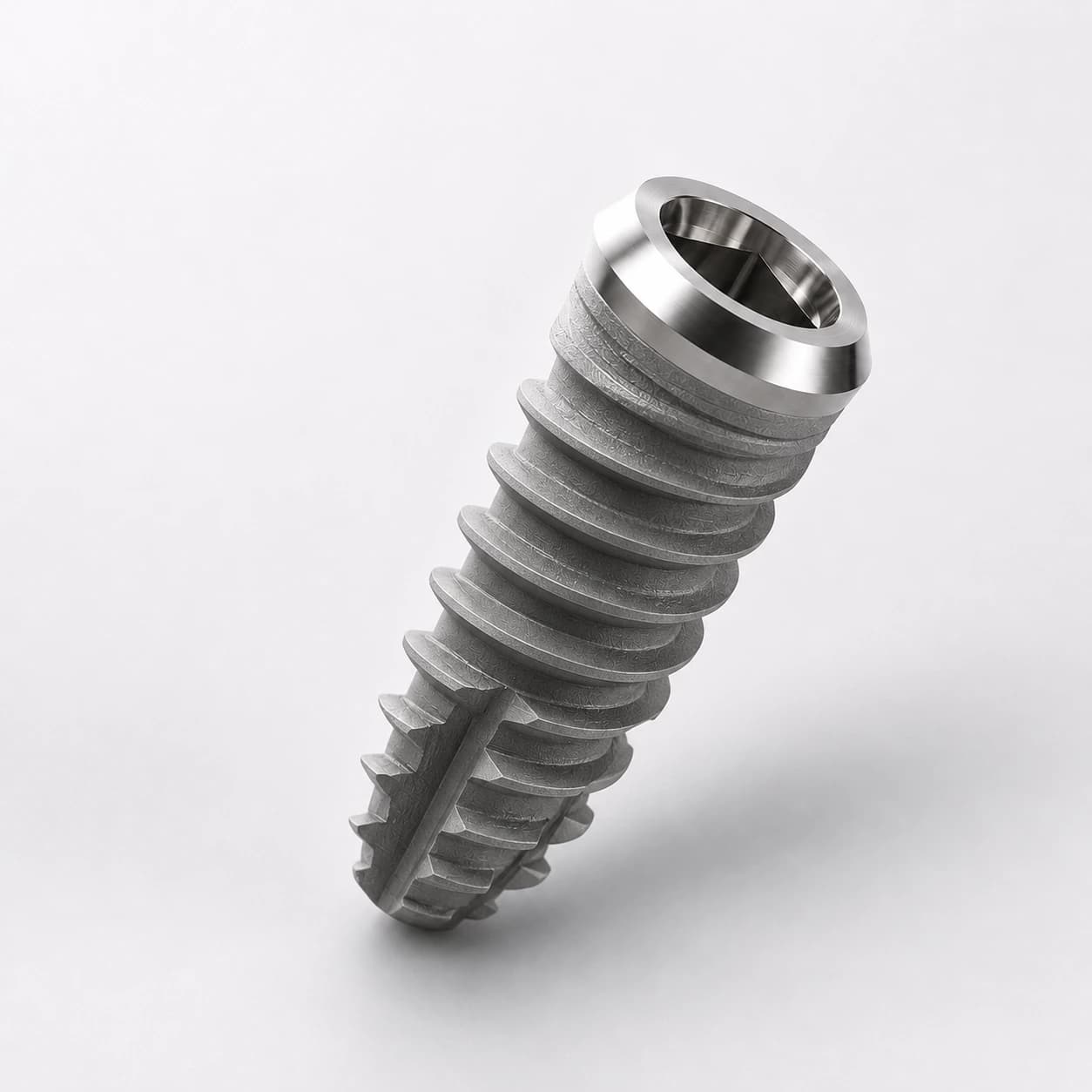 Detailed macro photo of a premium titanium dental implant on a clean white studio background